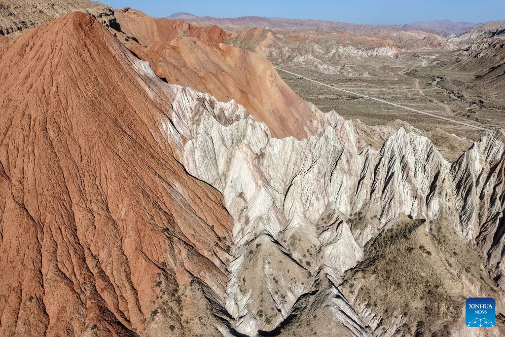 An aerial drone photo taken on July 7, 2026 shows the view of a geopark in Sunan Yugur Autonomous County of Zhangye, northwest China's Gansu Province. The geopark covers an area of 17.34 square kilometers. The park features unique landforms with towering peaks, rugged mountains, jagged rock pillars, and vibrant colors. (Photo: Xinhua)