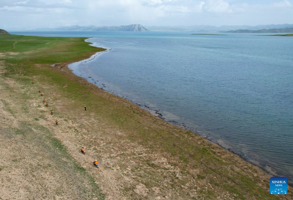 An aerial drone photo shows ecological conservation staff patrolling along the Donggi Cona Lake in Tibetan Autonomous Prefecture of Golog, northwest China's Qinghai Province, July 7, 2026. (Photo: Xinhua)