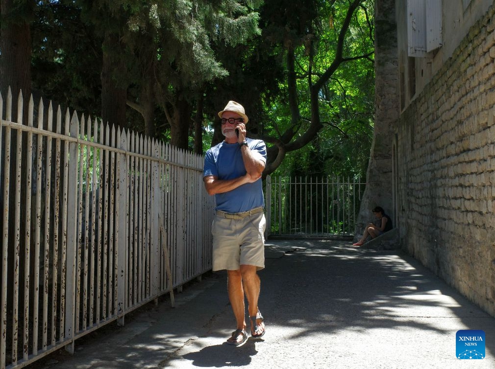 A man walks in the street amid high temperatures in Arles, France, July 8, 2026. France has experienced high temperatures this summer. (Photo: Xinhua)
