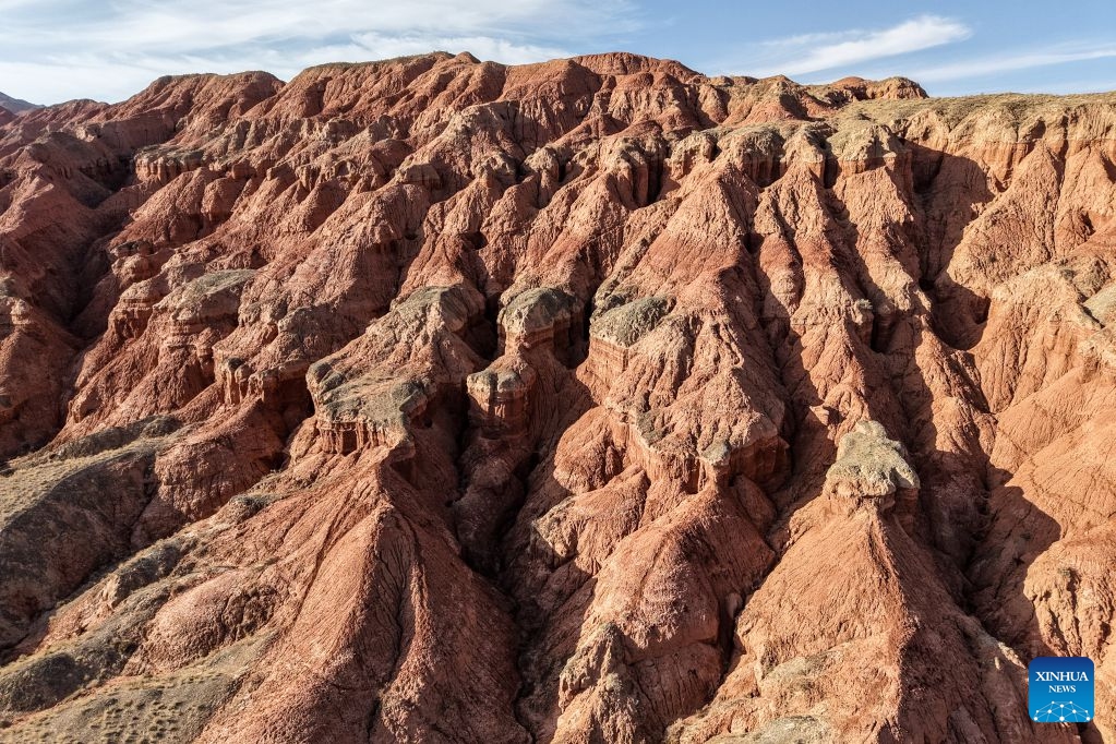 An aerial drone photo taken on July 7, 2026 shows the view of a geopark in Sunan Yugur Autonomous County of Zhangye, northwest China's Gansu Province. The geopark covers an area of 17.34 square kilometers. The park features unique landforms with towering peaks, rugged mountains, jagged rock pillars, and vibrant colors. (Photo: Xinhua)
