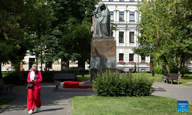 A woman walks past a statue of Russian writer Nikolai Gogol in a park in Moscow, Russia, July 6, 2026. (Photo: Xinhua)