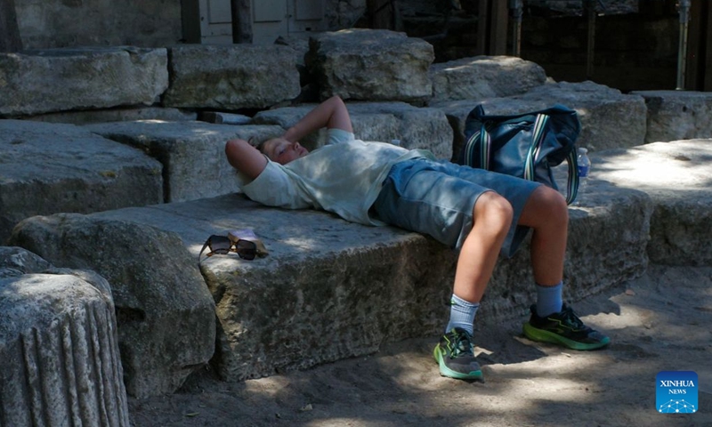 A boy rests inside the Roman theater in Arles, France, July 8, 2026. France has experienced high temperatures this summer. (Photo: Xinhua)
