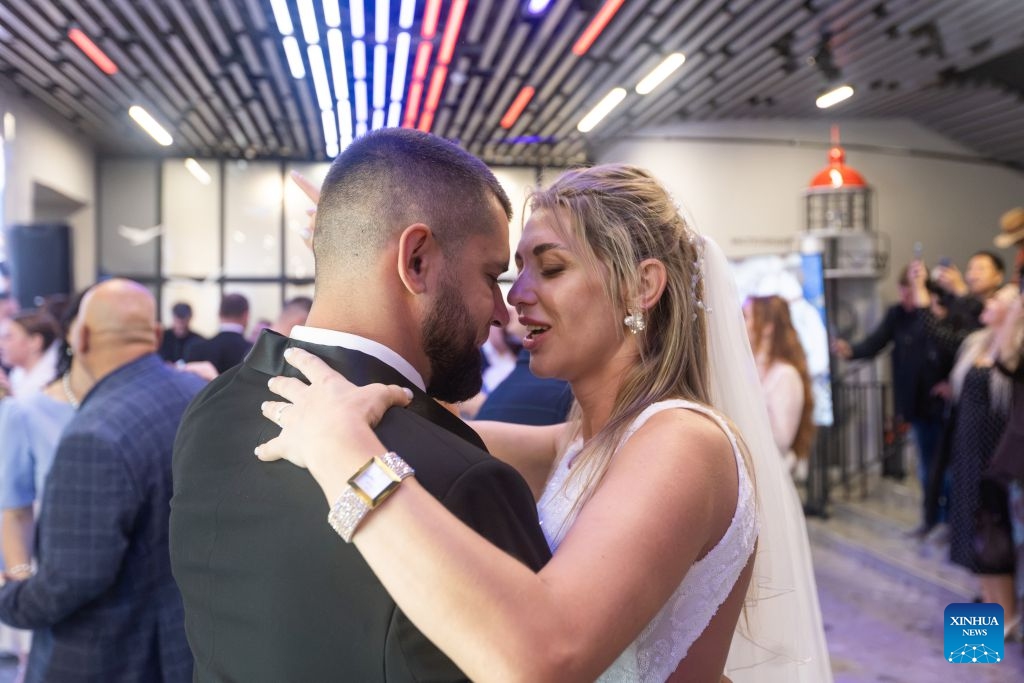 A couple dance during a group wedding in Vladivostok, Russia, July 8, 2026. Vladivostok held a Wedding Festival on Wednesday, with 11 couples registering their marriages and participating in a group wedding. (Photo by Andrey Matveenko/Xinhua)