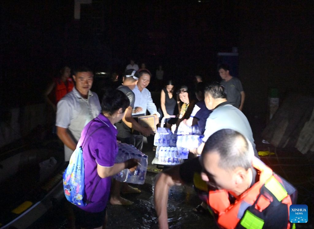 Rescuers deliver supplies to stranded residents in Guigang, south China's Guangxi Zhuang Autonomous Region, July 9, 2026.
Guigang has suffered severe flooding due to torrential rains brought by Typhoon Maysak and upstream inflows. Local authorities have mobilized rescue forces to work around the clock, making every effort to ensure basic living needs for stranded residents. (Xinhua/Zhou Hua)