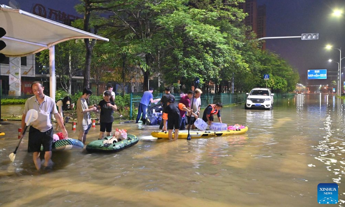 Rescuers wade through floodwater to deliver supplies to stranded residents in Guigang, south China's Guangxi Zhuang Autonomous Region, July 9, 2026.
Guigang has suffered severe flooding due to torrential rains brought by Typhoon Maysak and upstream inflows. Local authorities have mobilized rescue forces to work around the clock, making every effort to ensure basic living needs for stranded residents. (Xinhua/Zhou Hua)