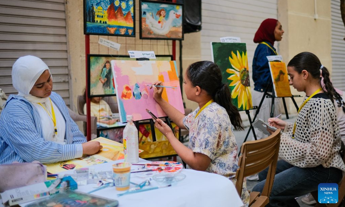 Young artists create artworks in downtown Cairo, Egypt, July 9, 2026. Egypt's government recently launched the Street of Art initiative, aiming to transform the streets and squares of the capital, Cairo, into open-air cultural spaces. Every Thursday through Saturday evening, the public can enjoy free cultural activities such as poetry readings, musical performances, and visual art exhibitions, attracting active participation from both citizens and tourists. (Xinhua/Xin Mengchen)