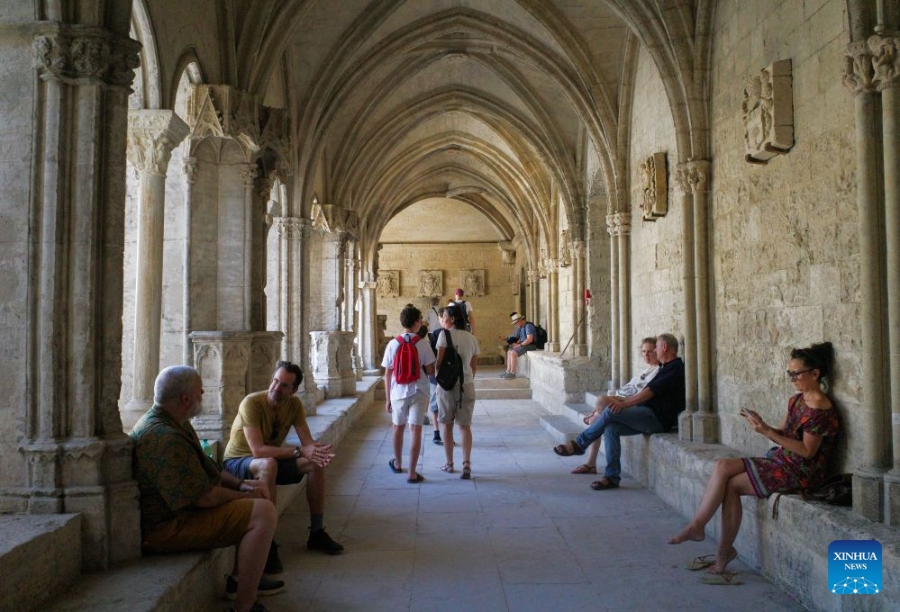 People visit in the cloister of the Church of St. Trophime in Arles, France, on July 8, 2026. (Xinhua/Wu Huiwo)