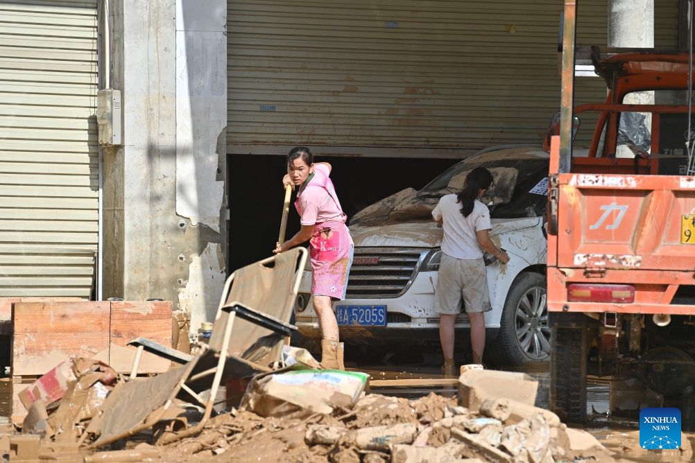 Residents clear a road in Guigang, south China's Guangxi Zhuang Autonomous Region, July 10, 2026. The local authorities beef up restoration efforts after torrential rains caused by Typhoon Maysak. (Photo: Xinhua)
