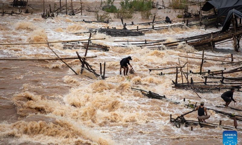 Fishermen catch fish in the Mekong River in Champasak Province, Laos, July 10, 2026. Champasak Province in southern Laos is home to the final section of the Mekong River running through the country, and well noted for a diverse array of river fish and rich aquatic resources. Many locals rely on fishing for their livelihood. (Photo: Xinhua)