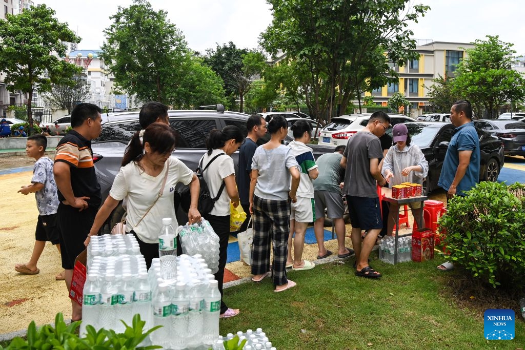Residents line up to receive relief supplies at a community in Guigang, south China's Guangxi Zhuang Autonomous Region, July 10, 2026. The local authorities beef up restoration efforts after torrential rains caused by Typhoon Maysak. (Photo: Xinhua)