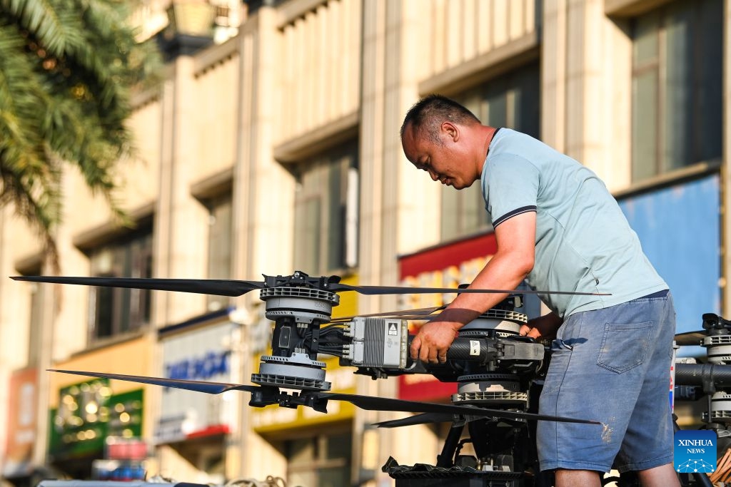 A man retreats his drone after a supply deployment in Guigang, south China's Guangxi Zhuang Autonomous Region, July 10, 2026. The local authorities beef up restoration efforts after torrential rains caused by Typhoon Maysak. (Photo: Xinhua)