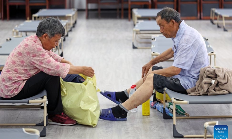 An elderly couple arrange belongings at a shelter in Jinshan District of east China's Shanghai, on July 11, 2026. Chinese authorities on Saturday intensified emergency response measures with Typhoon Bavi set to slam into the country's eastern coast, resulting in meteorological, water resources, transport and emergency management authorities issuing alerts and reinforcing flood-control efforts ahead of the expected landfall.