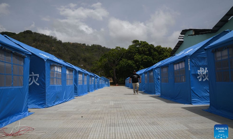 A man walks among tents donated by China for people affected by two earthquakes at a temporary camp in Catia la Mar, La Guaira state, Venezuela, on July 10, 2026. On the streets of Catia la Mar, a coastal town in La Guaira state and among the areas hit hardest by Venezuela's June 24 twin earthquakes, China's humanitarian aid has become a visible presence. (Photo by Marcos Salgado/Xinhua)