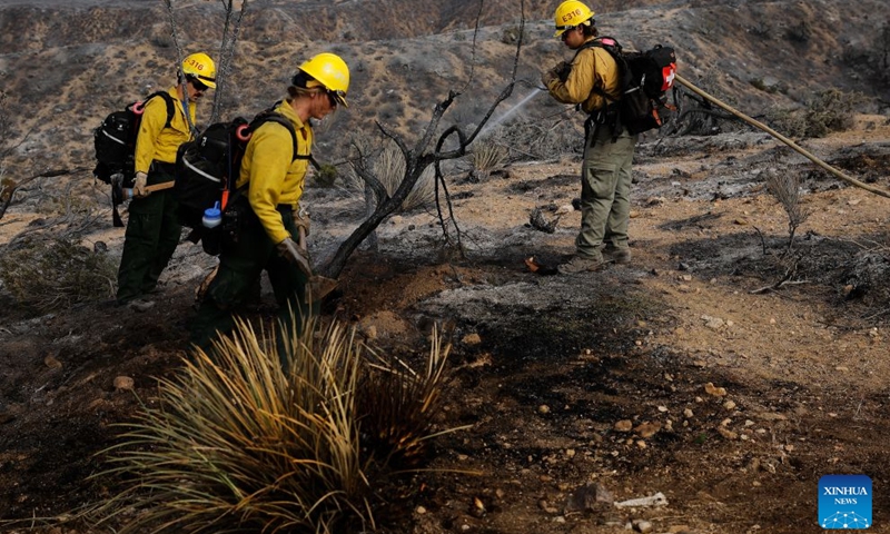Firefighters mop up debris after battling a brush fire in Antelope Valley, Los Angeles County, California, the United States, July 11, 2026. A wildfire burning in U.S. Southern California exploded to nearly 2,700 acres (about 10.9 square kilometers) Saturday, forcing evacuations amid dangerous heat wave. (Photo by Qiu Chen/Xinhua)