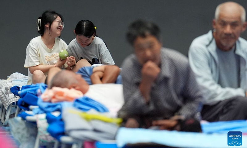 People are pictured at a temporary shelter in Pinggu District in Beijing, capital of China, July 11, 2026.

