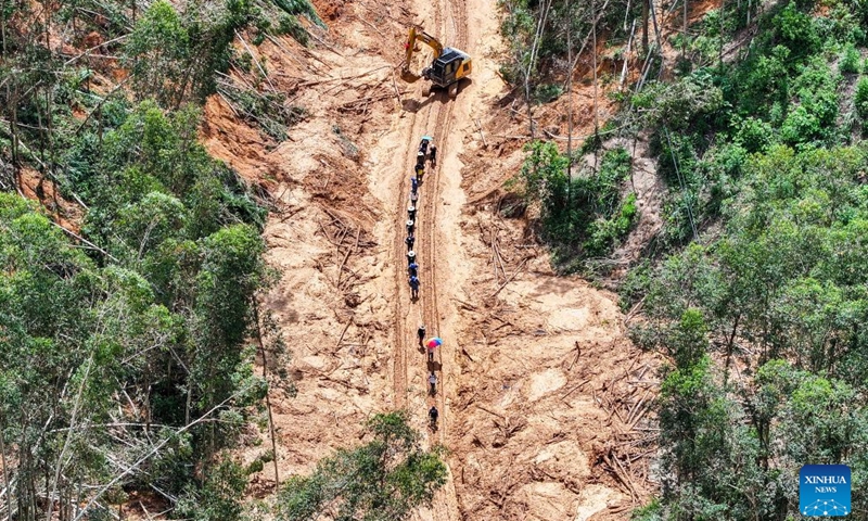 An aerial drone photo taken on July 11, 2026 shows rescuers clearing up a road leading to Zhenlong Township in Hengzhou, south China's Guangxi Zhuang Autonomous Region.(Xinhua/Huang Xiaobang)

