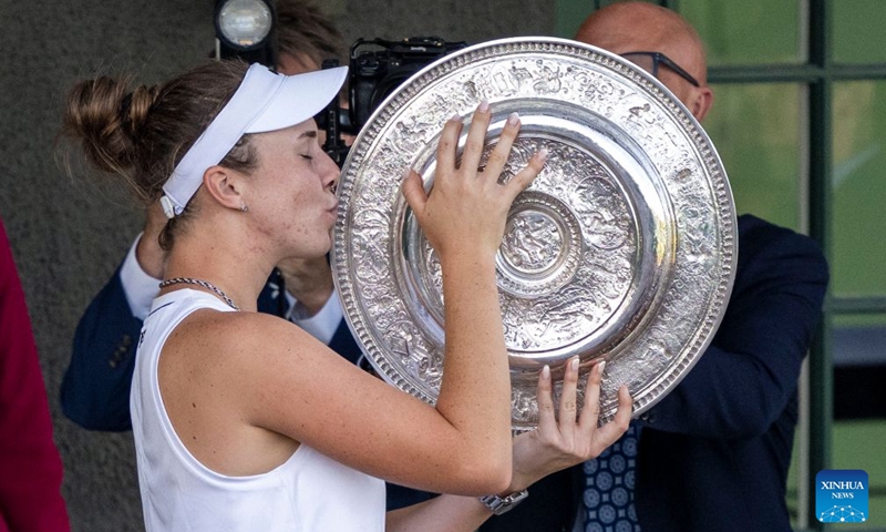 Linda Noskova of the Czech Republic kisses her trophy after winning the women's singles final against Karolina Muchova of the Czech Republic at the Wimbledon Tennis Championships in London, Britain, on July 11, 2026. (Photo by Stephen Chung/Xinhua)