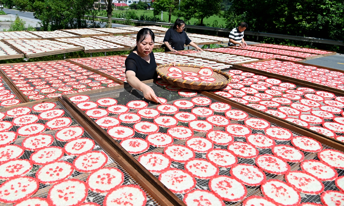 Villagers air-dry rice cakes in Dongkou, Central China's Hunan Province on July 12, 2026. Local authorities are promoting traditional food processing through a cooperative model to raise farm efficiency and rural incomes. Photo: VCG
