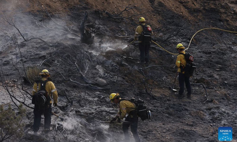 Firefighters mop up debris after battling a brush fire in Antelope Valley, Los Angeles County, California, the United States, July 11, 2026. A wildfire burning in U.S. Southern California exploded to nearly 2,700 acres (about 10.9 square kilometers) Saturday, forcing evacuations amid dangerous heat wave. (Photo by Qiu Chen/Xinhua)