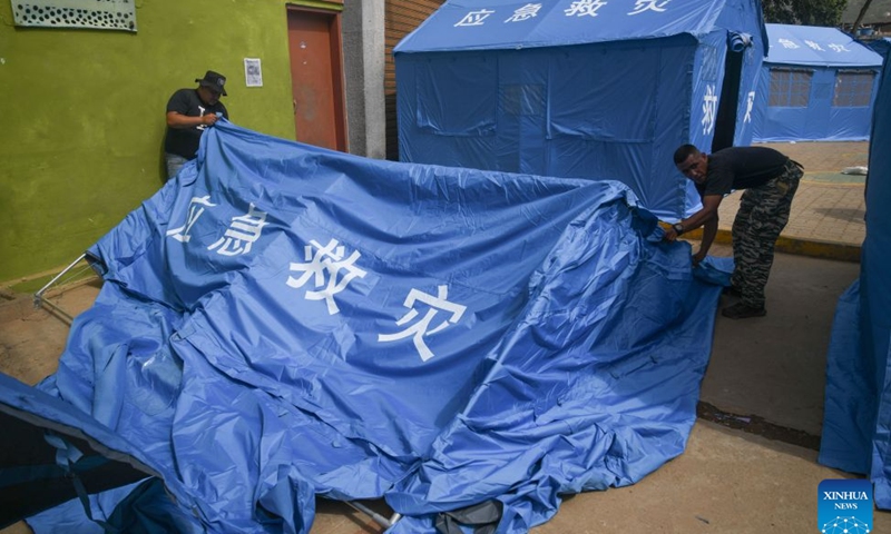 Members of the Bolivarian National Armed Forces set up a tent donated by China for people affected by two earthquakes at a temporary camp, in Catia la Mar, La Guaira state, Venezuela, on July 10, 2026. On the streets of Catia la Mar, a coastal town in La Guaira state and among the areas hit hardest by Venezuela's June 24 twin earthquakes, China's humanitarian aid has become a visible presence. (Photo by Marcos Salgado/Xinhua)