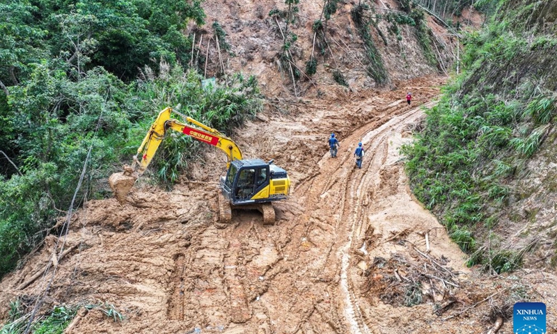 An aerial drone photo taken on July 11, 2026 shows rescuers clearing up a road leading to Zhenlong Township in Hengzhou, south China's Guangxi Zhuang Autonomous Region.