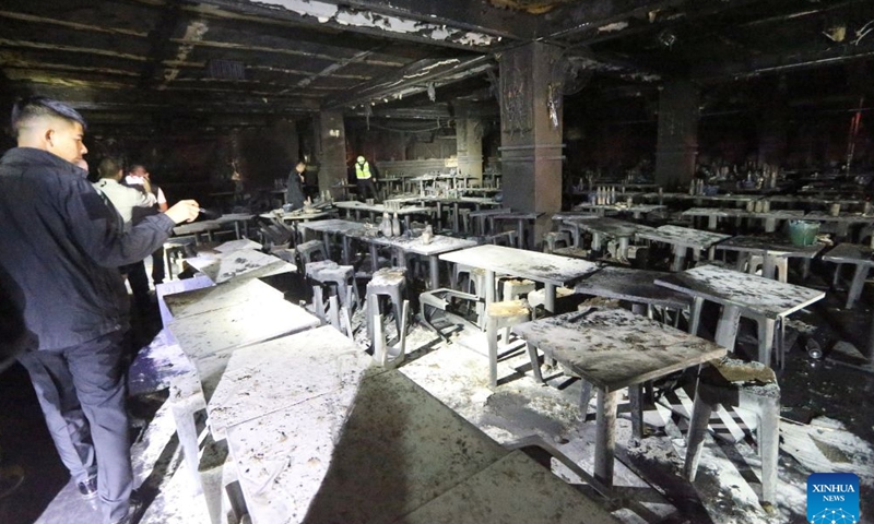 Rescuers work at a pub where a fire broke out in Bangkok, Thailand, July 13, 2026.
