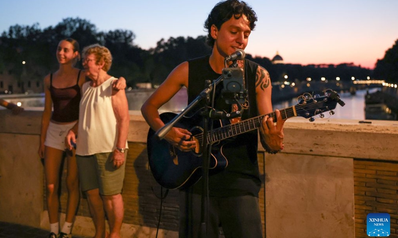 A singer sings along the Tiber River in Rome, Italy, July 12, 2026. The 24th edition of Along the Tiber Rome event is held here along the banks of the Tiber and will run until the end of August. It has become a popular summer event featuring culture, music and gastronomy. (Xinhua/Wang Kaiyan)
