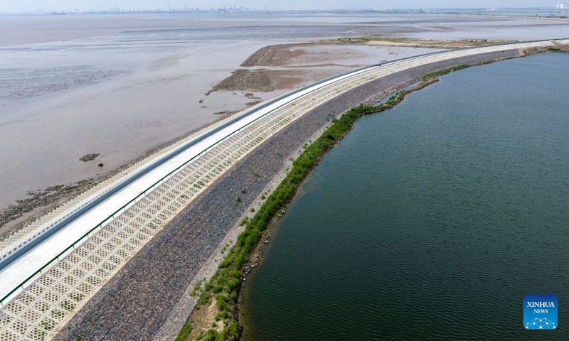 An aerial drone photo taken on July 12, 2026 shows a view of the first phase of a coastal seawall project in Binhai New Area in Tianjin, north China. The first phase of the coastal seawall project in Binhai New Area was fully completed. Stretching 3.4 kilometers, the new seawall boasts a crest elevation of 9.2 meters, approximately 2 meters higher than the original one, enabling it to better cope with the combined risks of typhoons, rainstorms and storm surges. (Xinhua/Zhao Zishuo)