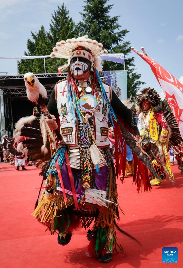 Members of Indigenous communities perform during the Squamish Nation Youth Pow-Wow in North Vancouver, British Columbia, Canada, on July 12, 2026. The annual event brought together Indigenous youth, dancers, drummers and community members to celebrate First Nations cultures, traditions and heritage through traditional songs, dances and ceremonies. (Photo by Liang Sen/ Xinhua)