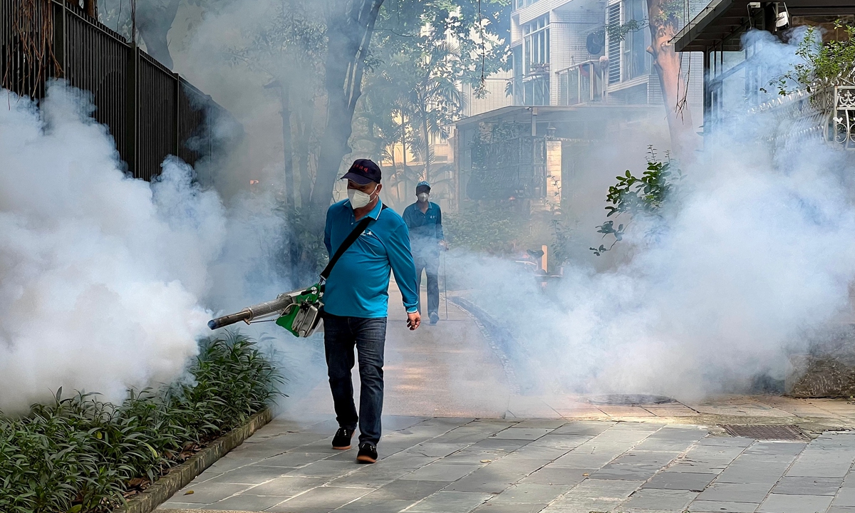 A community worker carries out thermal fogging to prevent mosquito-borne diseases in a greenbelt area in Guangzhou, South China's Guangdong Province, on July 13, 2026. Guangzhou has entered the peak season for mosquito-borne infectious diseases, with communities continuing mosquito control efforts. Photo: VCG