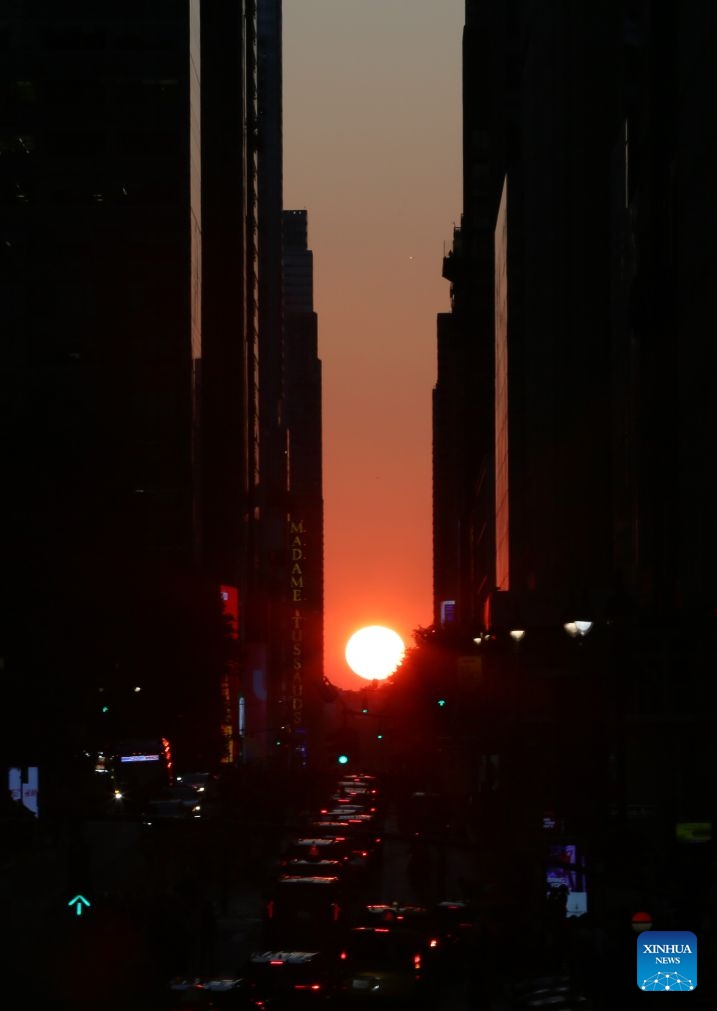 This photo taken on July 12, 2026 shows the Manhattanhenge in Manhattan of New York, the United States. The Manhattanhenge refers to the twice-a-year circumstance during which the setting sun aligns precisely with the east-west streets of Manhattan. (Xinhua/Zhang Fengguo)