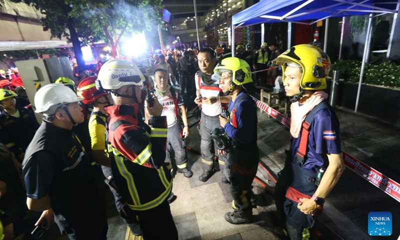 Rescuers gather at the scene after a fire broke out at a pub in Bangkok, Thailand, July 13, 2026. A fire at a pub near Lat Phrao Road in Bangkok's Chatuchak district killed 27 people and injured more than 10 others late Sunday, Thai media reported. The fire broke out at around 11:57 p.m. local time and was later extinguished. The injured were taken to hospitals for treatment. (Xinhua/Rachen Sageamsak)