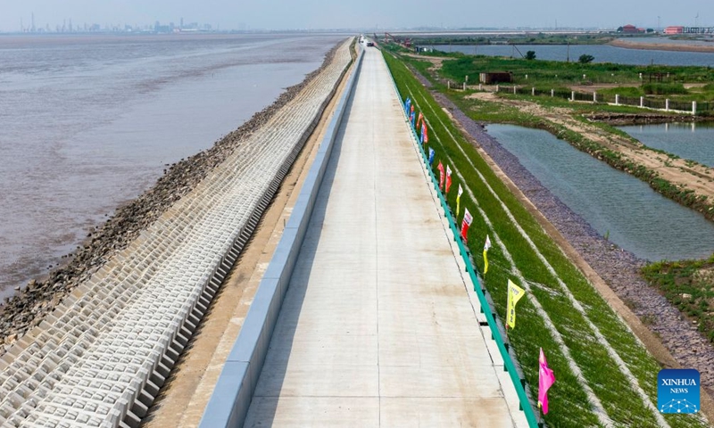 A drone photo taken on July 12, 2026 shows a view of the first phase of a coastal seawall project in Binhai New Area in Tianjin, north China. The first phase of the coastal seawall project in Binhai New Area was fully completed. Stretching 3.4 kilometers, the new seawall boasts a crest elevation of 9.2 meters, approximately 2 meters higher than the original one, enabling it to better cope with the combined risks of typhoons, rainstorms and storm surges. (Xinhua/Zhao Zishuo)