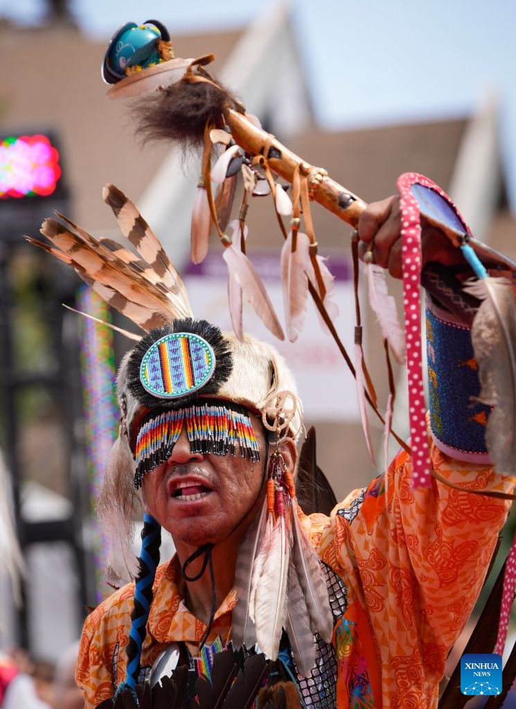 A member of Indigenous community performs during the Squamish Nation Youth Pow-Wow in North Vancouver, British Columbia, Canada, on July 12, 2026. The annual event brought together Indigenous youth, dancers, drummers and community members to celebrate First Nations cultures, traditions and heritage through traditional songs, dances and ceremonies. (Photo by Liang Sen/ Xinhua)