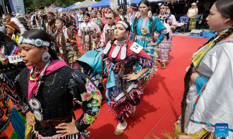 Members of Indigenous communities perform during the Squamish Nation Youth Pow-Wow in North Vancouver, British Columbia, Canada, on July 12, 2026. The annual event brought together Indigenous youth, dancers, drummers and community members to celebrate First Nations cultures, traditions and heritage through traditional songs, dances and ceremonies. (Photo by Liang Sen/ Xinhua)