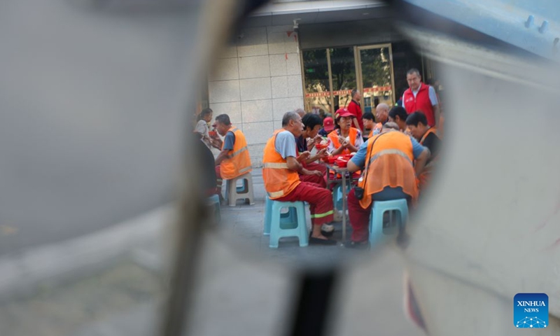 Sanitation workers have breakfast in Yanhu District, Yuncheng City, north China's Shanxi Province, July 8, 2026. (Xinhua/Yang Chenguang)

