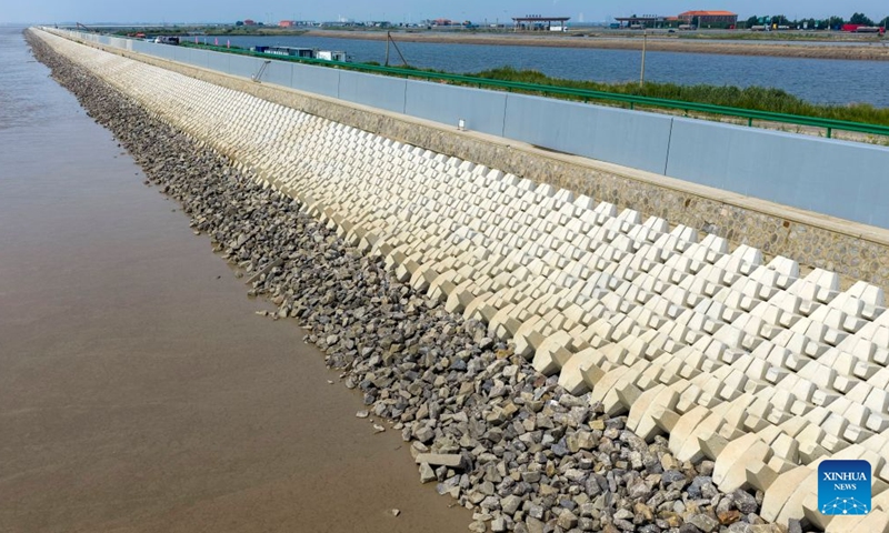 A drone photo taken on July 12, 2026 shows a view of the first phase of a coastal seawall project in Binhai New Area in Tianjin, north China. The first phase of the coastal seawall project in Binhai New Area was fully completed. Stretching 3.4 kilometers, the new seawall boasts a crest elevation of 9.2 meters, approximately 2 meters higher than the original one, enabling it to better cope with the combined risks of typhoons, rainstorms and storm surges. (Xinhua/Zhao Zishuo)