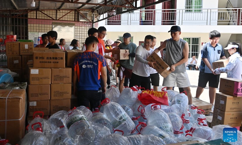Volunteers unload relief supplies at a charity federation in Nanning, south China's Guangxi Zhuang Autonomous Region, July 12, 2026. Typhoon Maysak brought torrential rains to south China's Guangxi. The local authorities have launched public aid appeals for funds and relief supplies, drawing donations from enterprises, public institutions, social organizations and individuals across the country to help affected residents recover from the disaster. (Xinhua/Lu Boan)