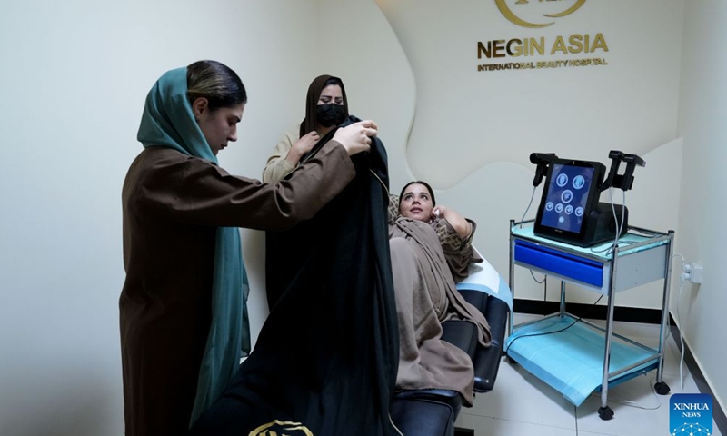 Cosmetologists perform skin treatment for a patient at a beauty clinic in Kabul, Afghanistan, July 2, 2026. A dermatology and aesthetic hospital in Kabul is expanding access to modern skin treatment services for Afghan patients, with Chinese-made medical equipment and skincare products helping doctors provide high-quality and affordable care for a wide range of skin conditions.(Photo by Saifurahman Safi/Xinhua)