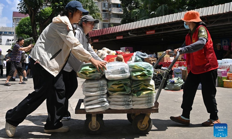 Volunteers transfer relief supplies at a charity federation in Nanning, south China's Guangxi Zhuang Autonomous Region, July 12, 2026. Typhoon Maysak brought torrential rains to south China's Guangxi. The local authorities have launched public aid appeals for funds and relief supplies, drawing donations from enterprises, public institutions, social organizations and individuals across the country to help affected residents recover from the disaster. (Xinhua/Lu Boan)