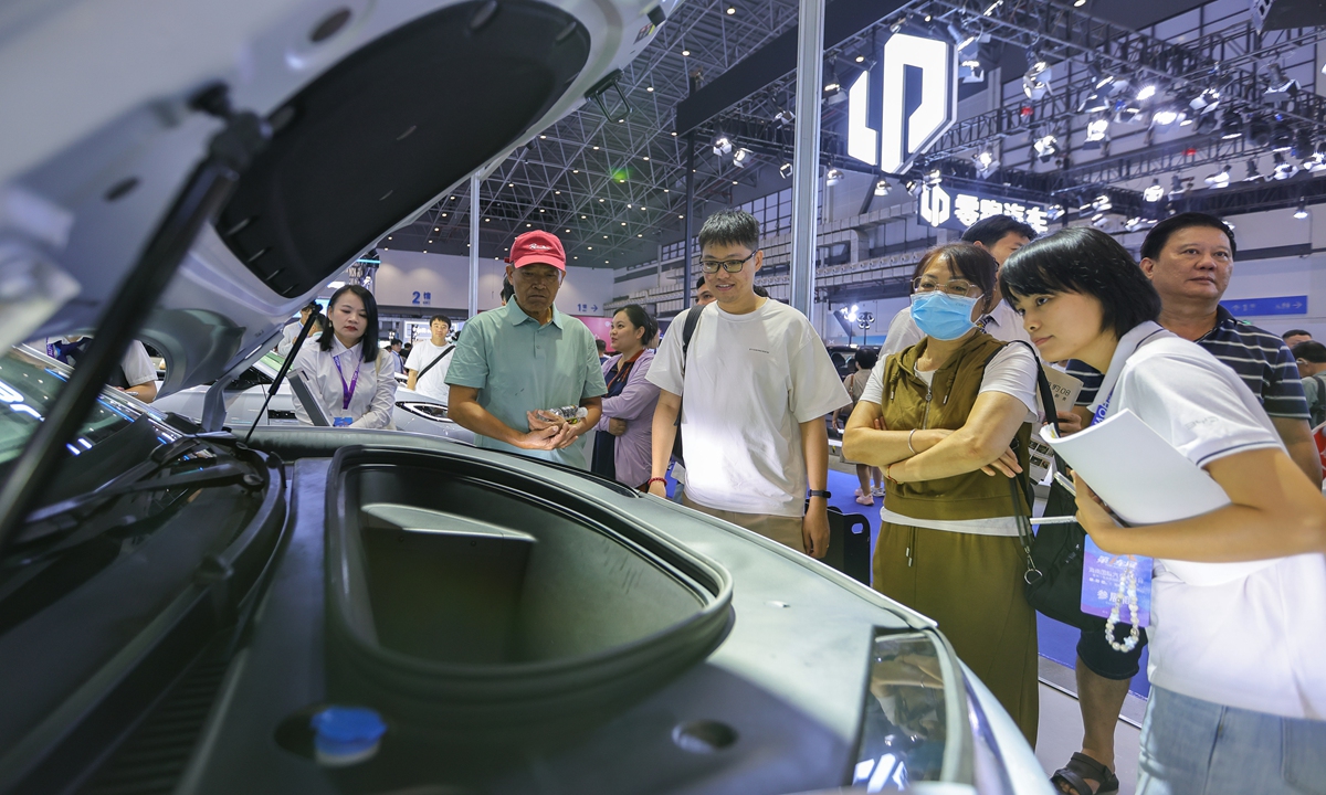 Visitors check out the front trunk of a new energy vehicle at the 2026 Hainan International Auto Expo and the 8th Hainan International New Energy Vehicle Exhibition in Haikou, South China's Hainan Province, on July 9, 2026. Photo: VCG