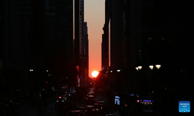 This photo taken on July 12, 2026 shows the Manhattanhenge in Manhattan of New York, the United States. The Manhattanhenge refers to the twice-a-year circumstance during which the setting sun aligns precisely with the east-west streets of Manhattan. (Xinhua/Zhang Fengguo)