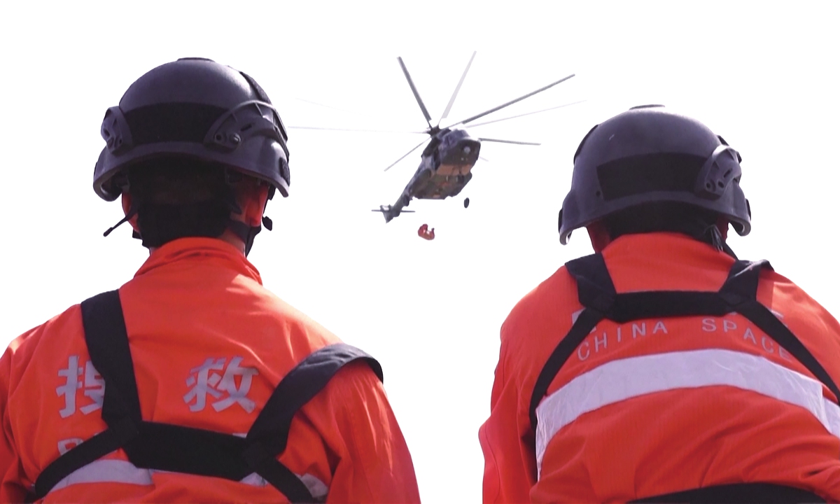 Two search and rescue team members take part in the Shenzhou-15 spacecraft's return mission.