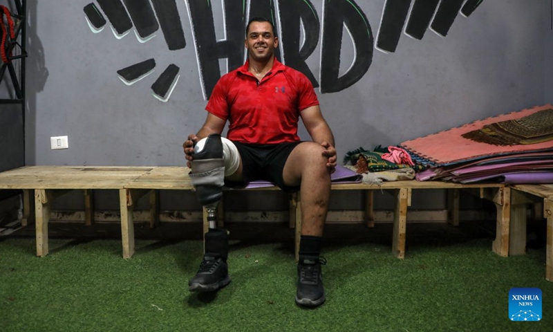 Palestinian bodybuilding coach Mahmoud Abu Madkour poses for a photo at the modest Al-Sakhra gym, in al-Nuseirat refugee camp in the central Gaza Strip, on July 8, 2026. (Photo by Rizek Abdeljawad/Xinhua)

