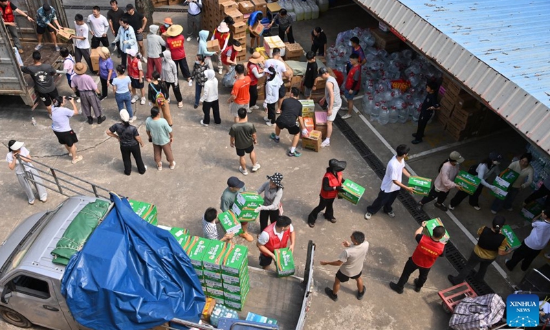 Volunteers unload relief supplies at a charity federation in Nanning, south China's Guangxi Zhuang Autonomous Region, July 12, 2026. Typhoon Maysak brought torrential rains to south China's Guangxi. The local authorities have launched public aid appeals for funds and relief supplies, drawing donations from enterprises, public institutions, social organizations and individuals across the country to help affected residents recover from the disaster. (Xinhua/Lu Boan)