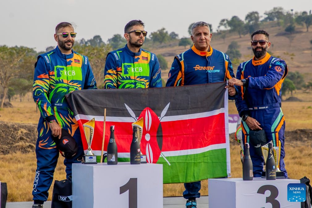 A Kenyan flag is displayed by the winners of 1st and 3rd place of the Rwanda Mountain Gorilla Rally in Bugesera, Rwanda, July 12, 2026. The Rwanda Mountain Gorilla Rally is one of four official rounds of the 2026 FIA African Rally Championship. (Photo by Cyril Ndegeya/Xinhua)