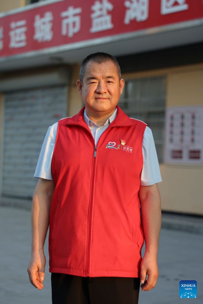 This photo taken on July 8, 2026 shows the portrait of Zhang Changqin, head of the volunteer association in Yanhu District, Yuncheng City, north China's Shanxi Province. (Xinhua/Yang Chenguang)


