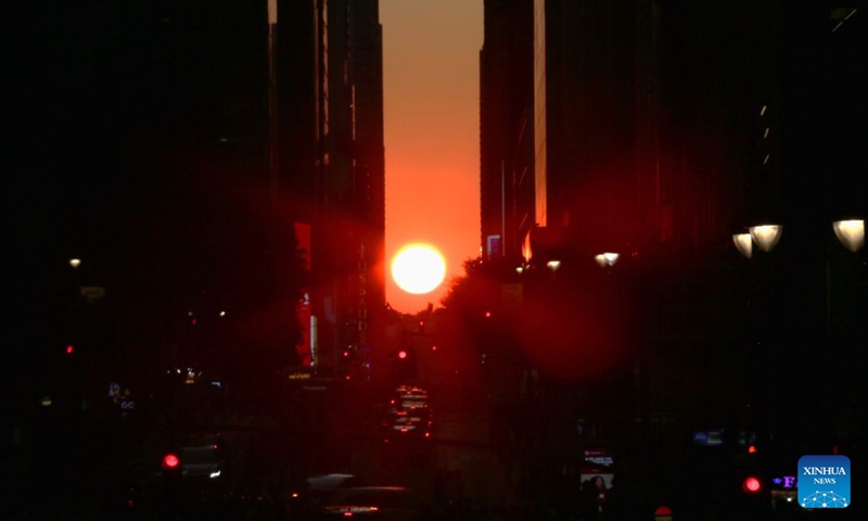 This photo taken on July 12, 2026 shows the Manhattanhenge in Manhattan of New York, the United States. The Manhattanhenge refers to the twice-a-year circumstance during which the setting sun aligns precisely with the east-west streets of Manhattan. (Xinhua/Zhang Fengguo)
