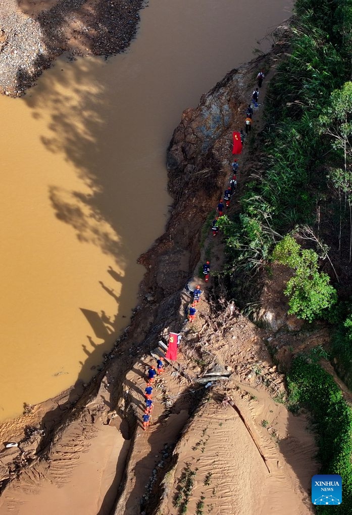 An aerial drone photo shows a rescue team pushing into stranded villages in Zhenlong Township, Hengzhou City, Nanning, south China's Guangxi Zhuang Autonomous Region, July 11, 2026.

