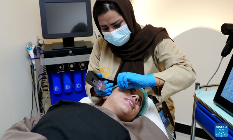 A cosmetologist performs skin treatment for a patient at a beauty clinic in Kabul, Afghanistan, July 2, 2026. A dermatology and aesthetic hospital in Kabul is expanding access to modern skin treatment services for Afghan patients, with Chinese-made medical equipment and skincare products helping doctors provide high-quality and affordable care for a wide range of skin conditions.(Photo by Saifurahman Safi/Xinhua)